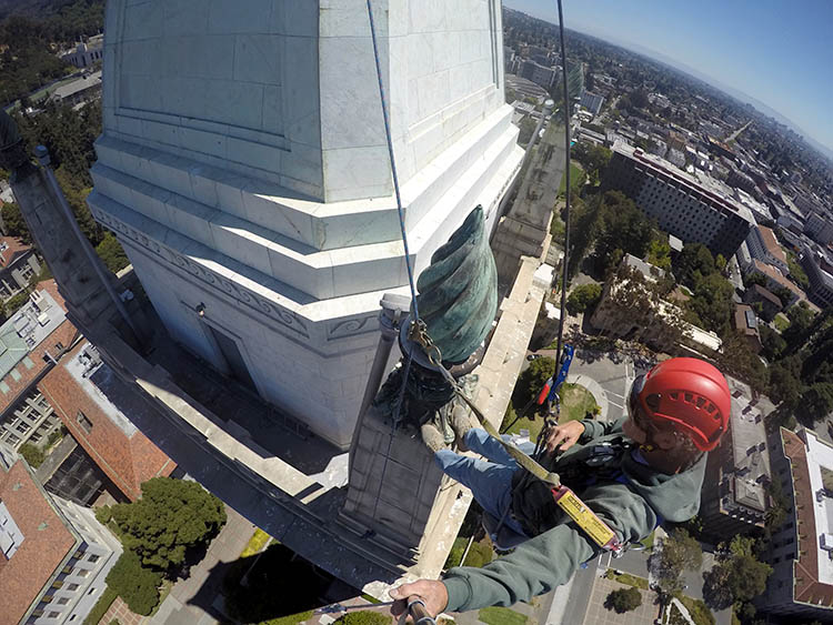 a man takes a photo at the top of the bell tower