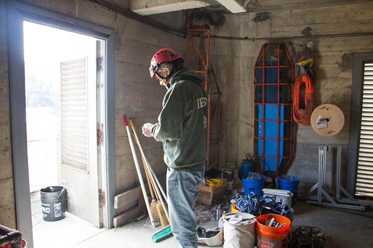 a man examines equipment in a small space