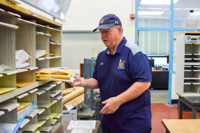 Mike Combs sorting mail