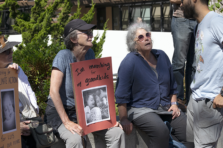 two women talking to someone at climate strike