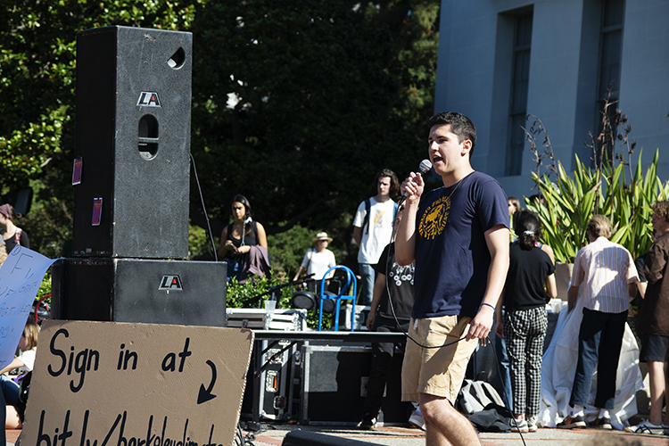 Event organizer Dante Gonalez speaking on stage during climate strike