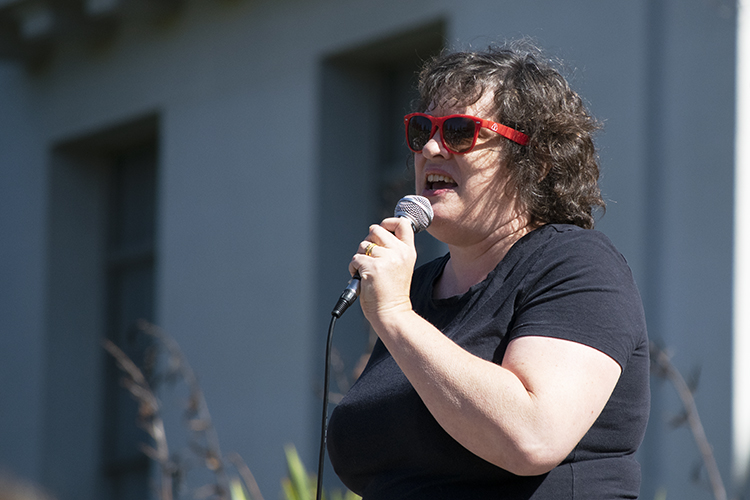 professor kate o'neill speaks to the crowd during a teach-in