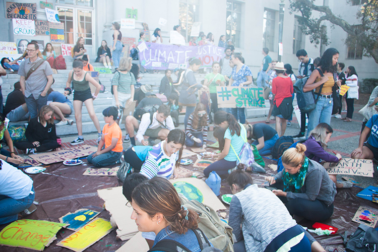 Berkeley students work on signs for climate strike