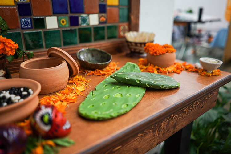 A student made cacti out of clay for her Day of the Dead altar.