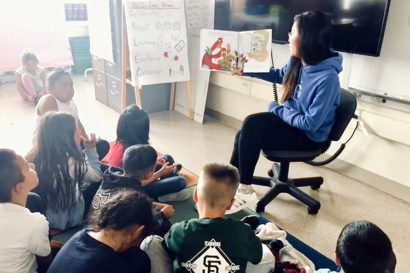 tiffany yu reads to a second grade class