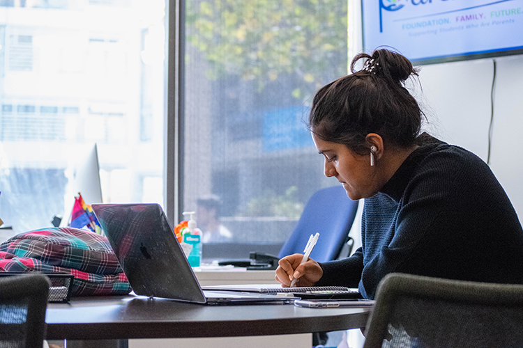 A student does homework at the Transfer Student Center