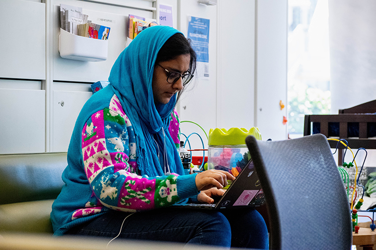 A student works on her laptop in the Transfer Student Center.