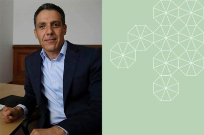 Hany Farid sits at a desk looking at the camera