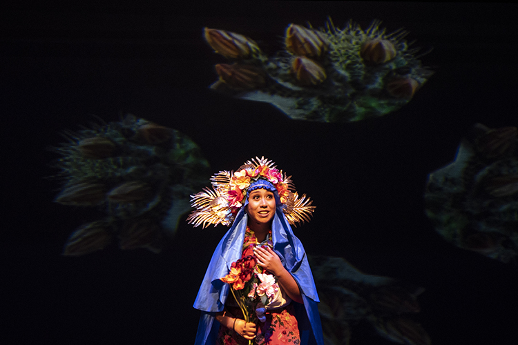 actor wearing beautiful outfit standing in middle of stage