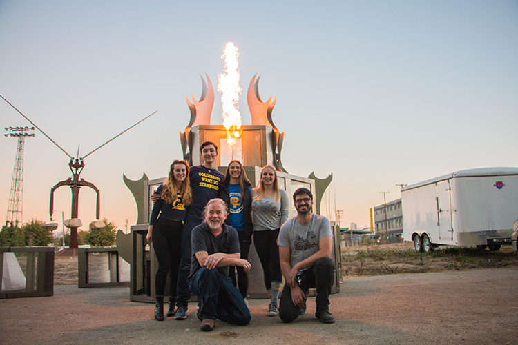 The work team poses with the bonfire apparatus.