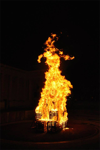 A photo of a wood-burning bonfire at the Greek Theatre during a Big Game Bonfire Rally..