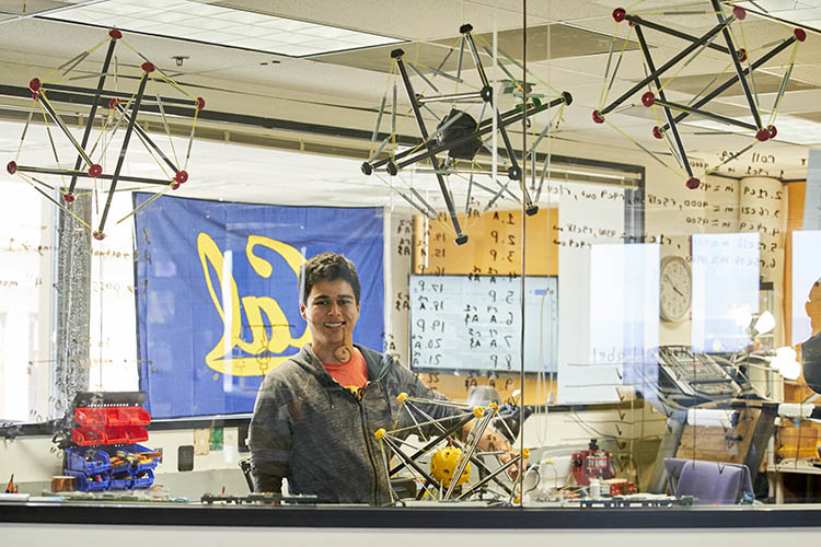 a member of skydeck looks at the camera in a busy work space