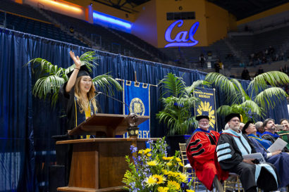 student han na choi waves at a podium