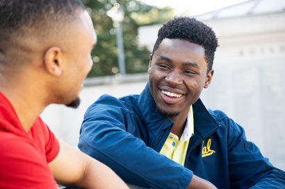 Chaka Tellem laughs as he talks to a friend
