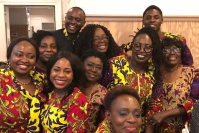 A group of people smiling at a family reunion