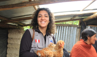 Neeka Mahdavi holds a chicken in Peru