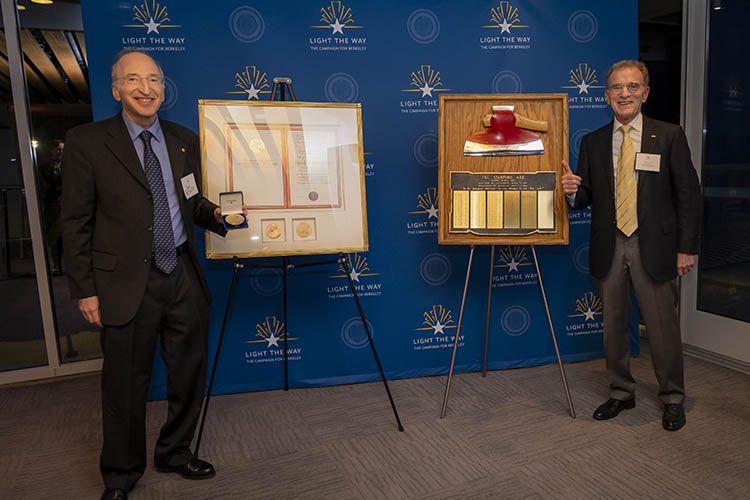 Randy Schekman and Saul Perlmutter pose in front of their awards