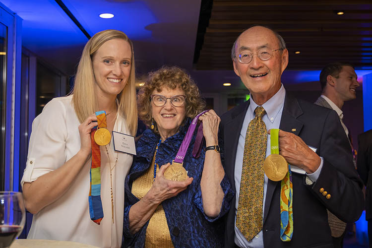 Vollmer shows off three Olympic medals with two other people