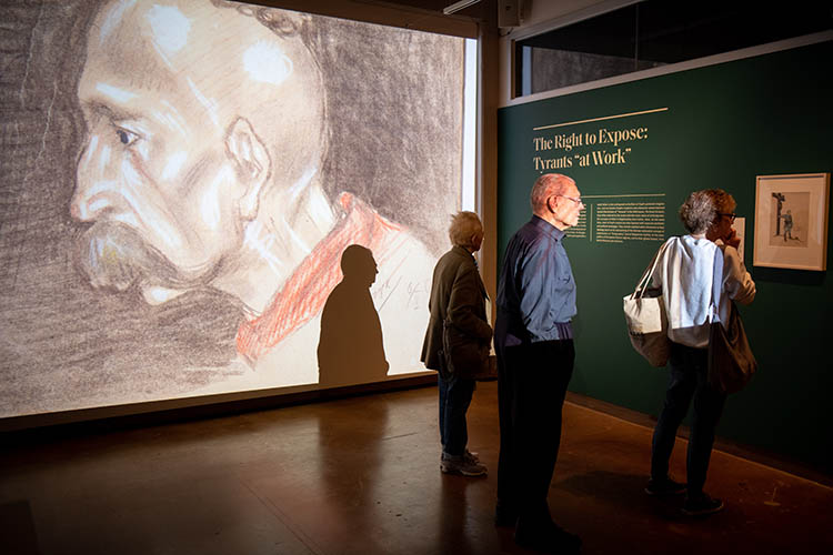 people look at an exhibit about Arthur Szyk at the Magnes museum