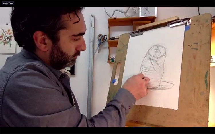 Danny Neece drawing on a sheet of paper