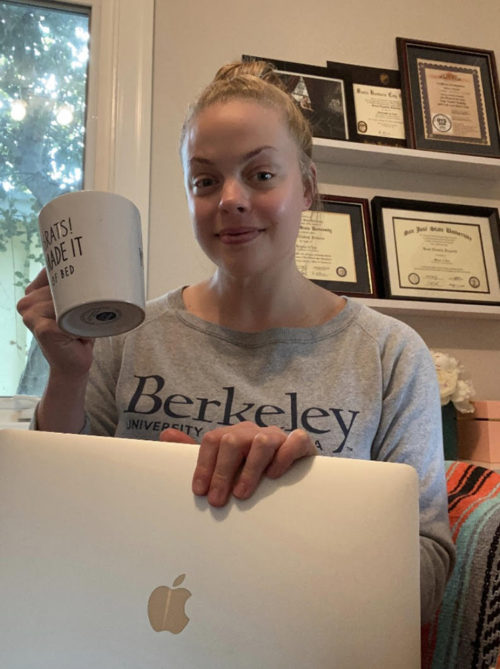 Sarah Fullerton holding a mug and lap top