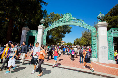 Students walk under Sather Gate