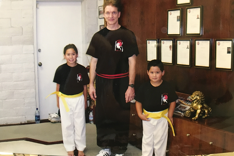 A young Micaela Camozzi with her little brother and Kung Fu instructor