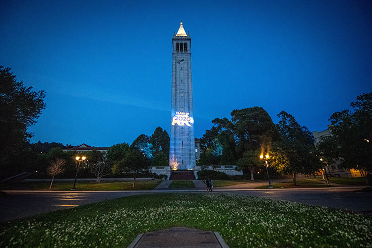 Sather Tower with a projection saying 