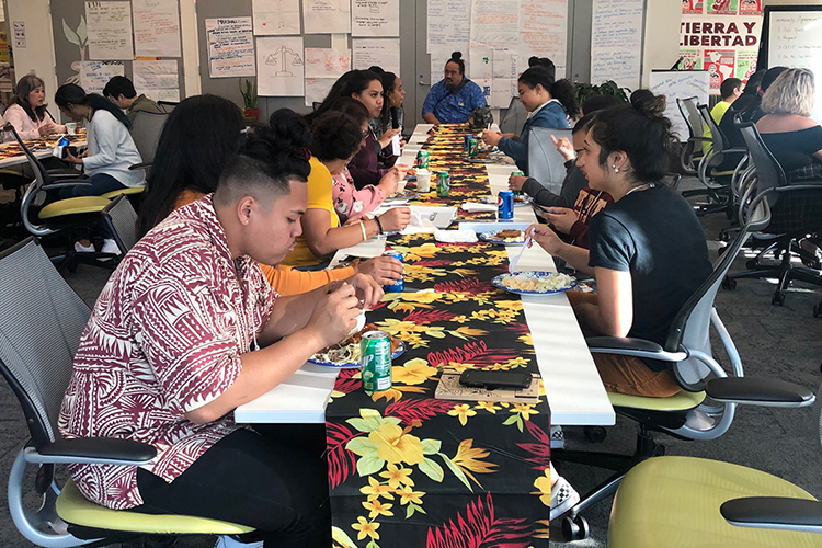 Students eating at a table during a workshop