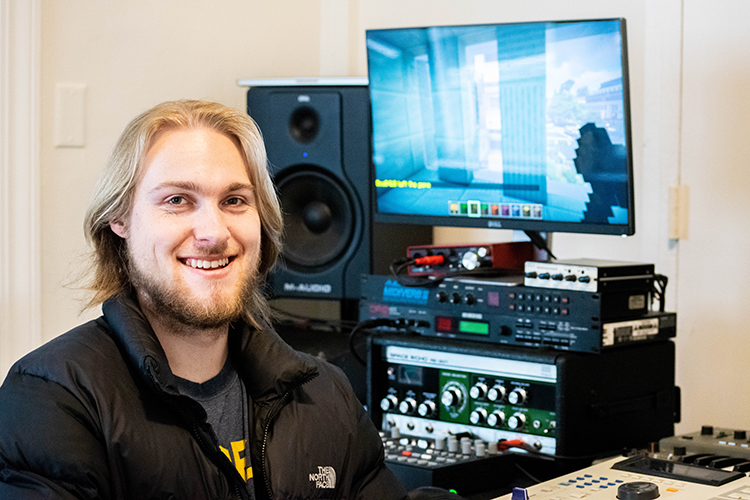 Bjorn Lustic sits in front of a computer