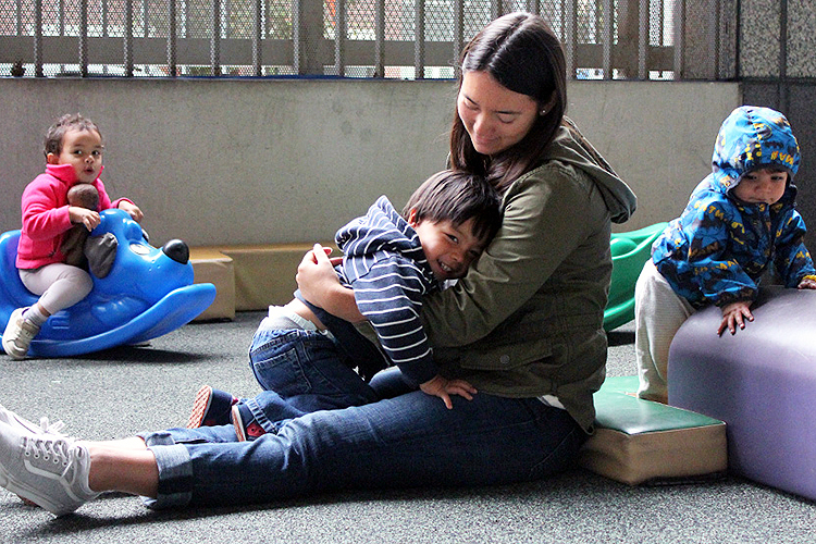 Child care worker with young children