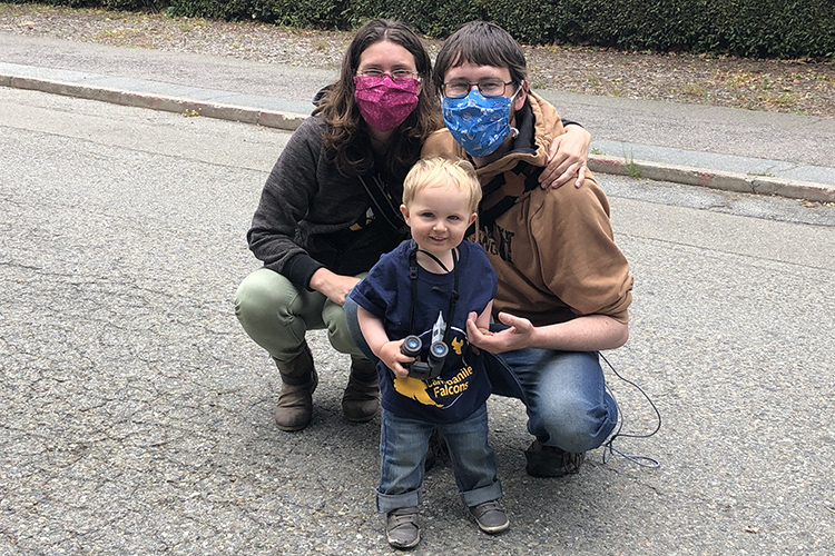 The couple who run the popular Cal Falcons website pose in face masks with their young son, Vireo, who's named after a bird species.