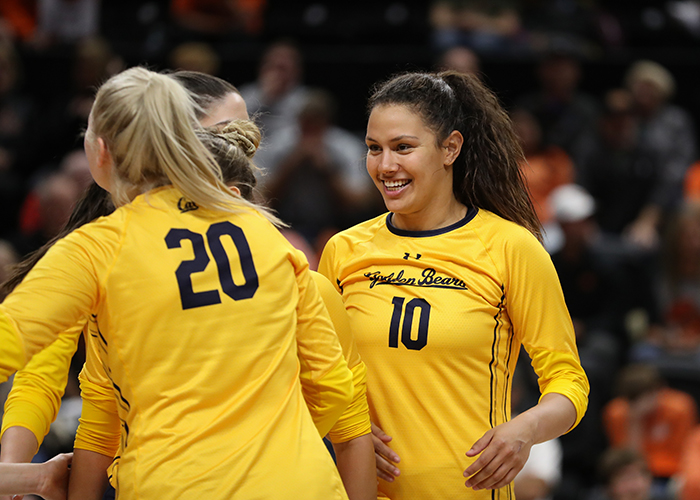 Berkeley volleyball player Preslie Anderson smiling on court with her teamates