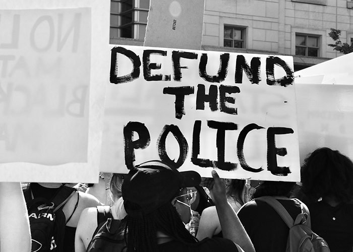 Demonstrators at a George Floyd protest holding up a 