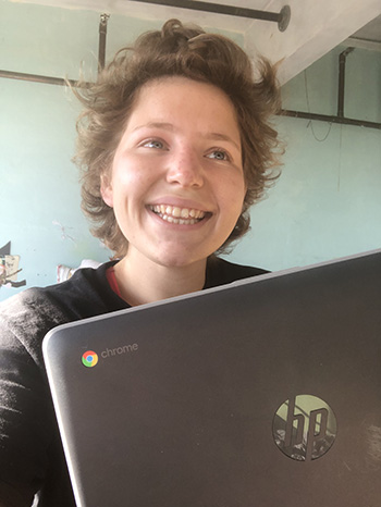 Student Sam Good smiles with her free HP Chromebook, which was given to her by the Student Technology Fund when the coronavirus pandemic shut down the campus.