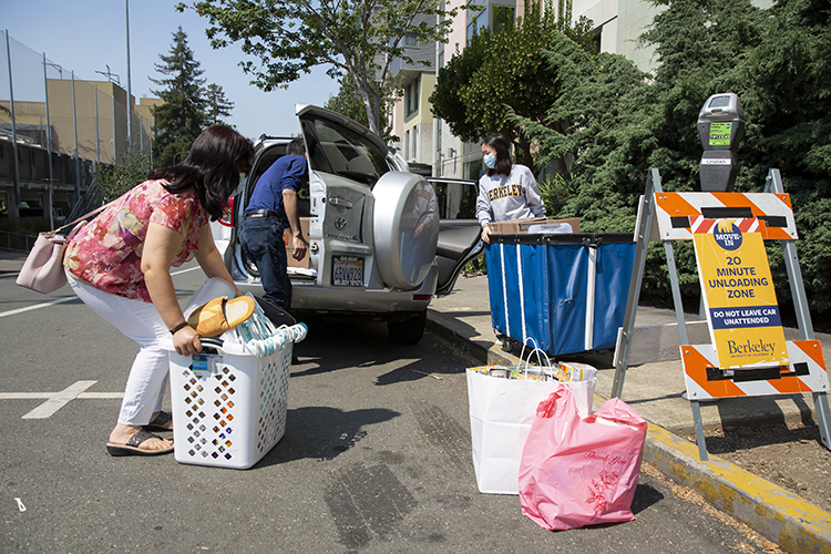 A family from San Francisco unloads the daughter's belongings outside of a residence hall on one of this fall's move-in days.