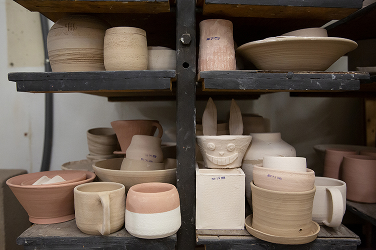 Pottery sits on shelving in the ASUC Art Studio, which is offering online pottery classes during the pandemic.