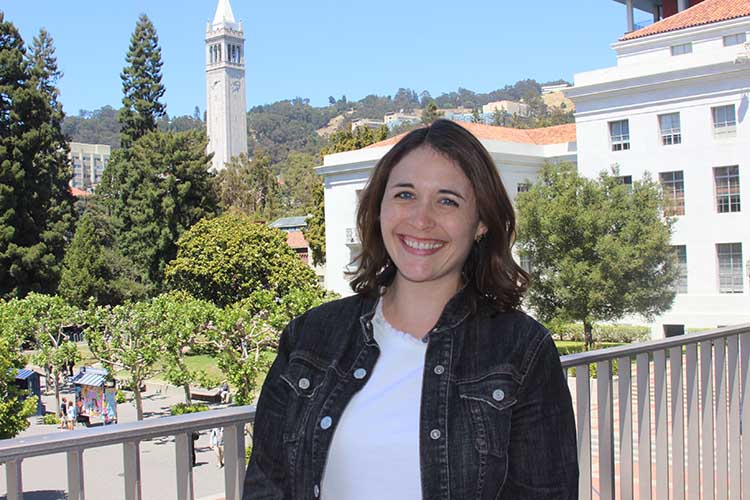 Micki Antovich, Berkeley's assistant dean of students and director of New Student Services, poses outside of the ASUC building with the Campanile in the background.