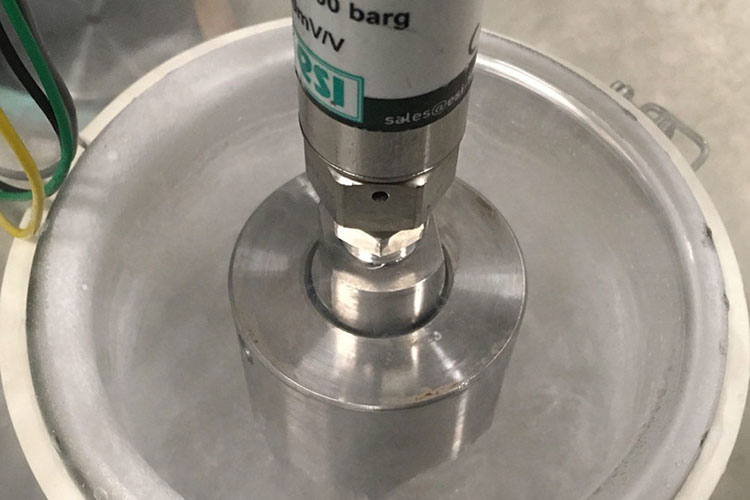 A photo of a metal lid on a vacuum chamber