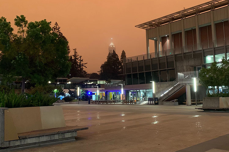 A view from Lower Sproul Plaza on Sept. 10 shows an orange sky around 9 a.m. with lights still on from the plaza to the Campanile.