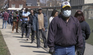 Wisconsin residents wait in long lines during the state's primary election in April 2020