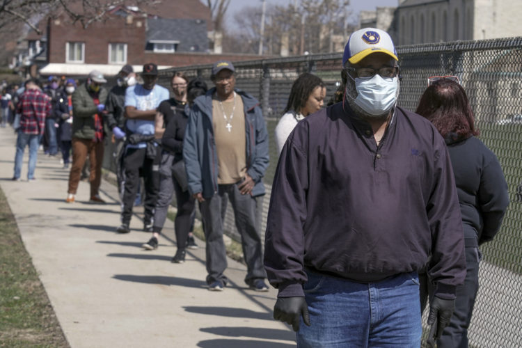 Wisconsin residents wait in long lines during the state's primary election in April 2020