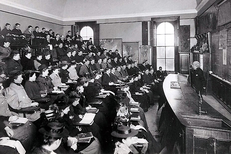 archival photo of a lecture room in Berkeley with some of the first female students