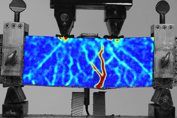 A photo taken with a special camera shows a block of engineered concrete. The camera is able to reveal the strain in the new concrete under compression.