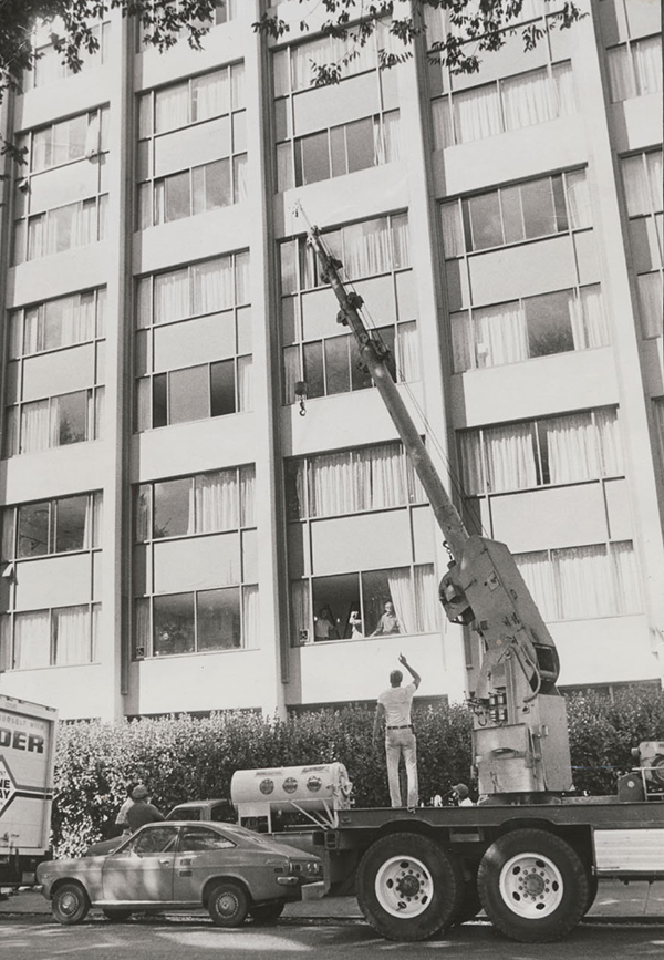 a crane lifts mark o'brien's iron lung through his dorm room window
