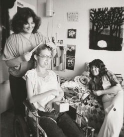Three women relax in a dormitory