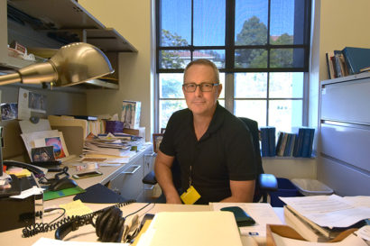 Martin Meeker sits at his desk in his office