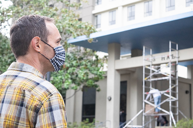 UC Berkeley Ph.D. student Alec Stewart watches the lettering coming down from Barrows Hall, which was named after his great-great-grandfather, David Barrows.