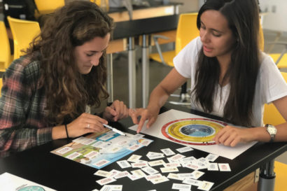 2 high school girls working with teaching tools
