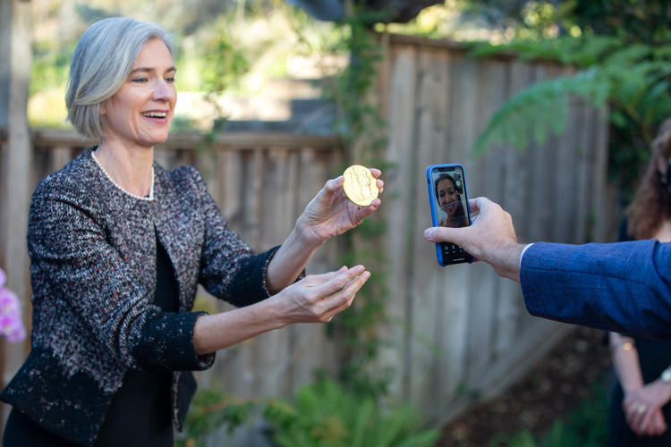 Doudna showing medal to sister through cellphone